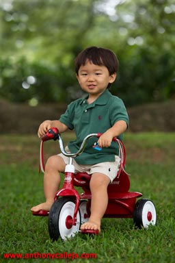 Child on a tricycle, Moanalua Gardens, Honolulu, Hawaii
