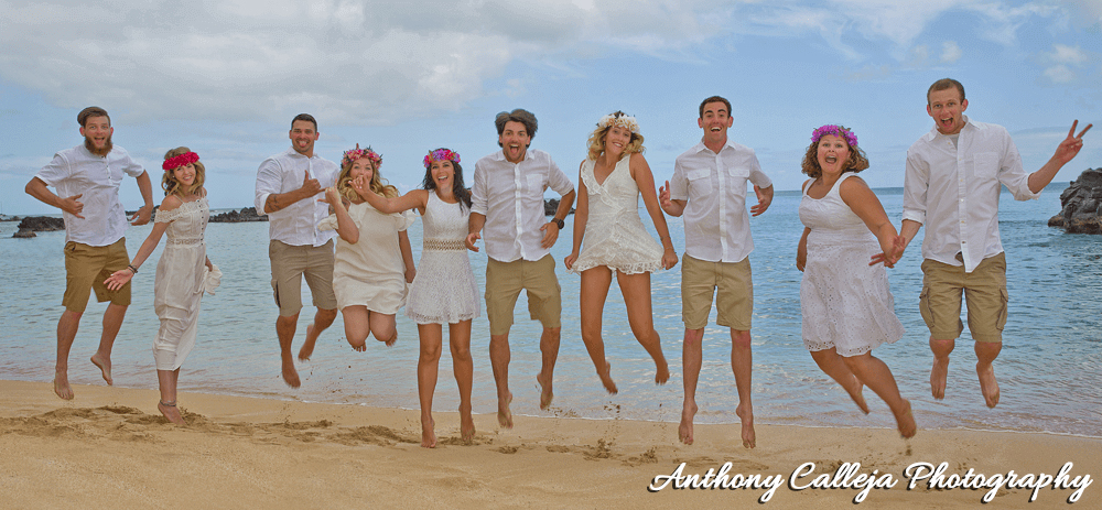 Family of ten Jumping in the air and having a good time at Waimea Bay Beach, North Shore, Oahu