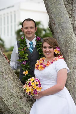 Oahu Temple Wedding Portrait of the Bride and groom near a tree, Laie Temple in the background