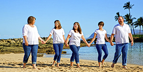 Early Bird Portrait Special - Paradise Cove Family holding hands walking on the beach