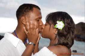 Couple's first kiss photographed at Eternity Beach Oahu Hawaii