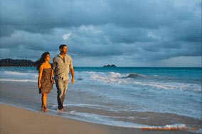 young couple walking on the beach sunrise at Waimanalo Beach Oahu Hawaii