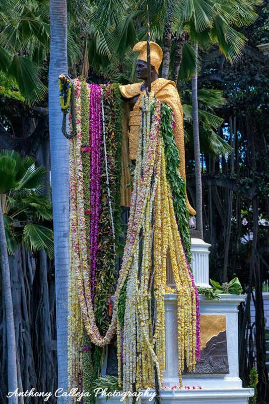 King Kamehameha statue draped with flower leis in celebration of Kamehameha Day