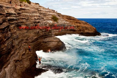 Cliff Jumper dives in the waters at Spitting Cave of Portlock