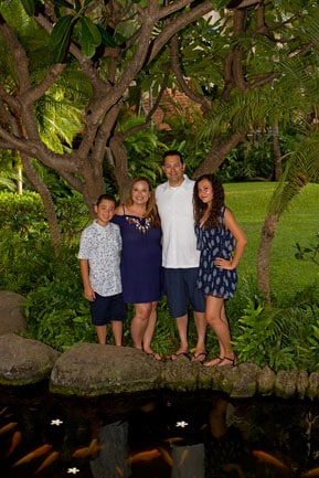 Hilton Hawaiian Village Family Portrait Photography - Family of four standing in the garden near the koi pond