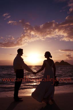 Sunrise Silhouette of Bride and groom holding hands at the beach. Honolulu Beach Wedding Portrait Photographers