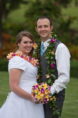 Bride and Groom holding flowers in a garden at laie Temple